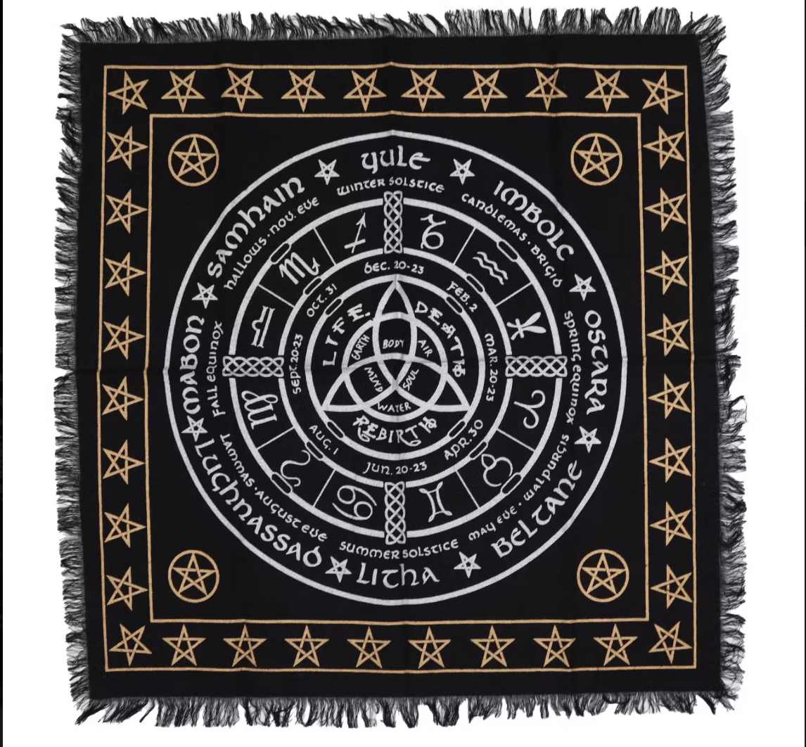 Black cloth with white symbols and text, featuring a central circular design with stars and pentagrams.
