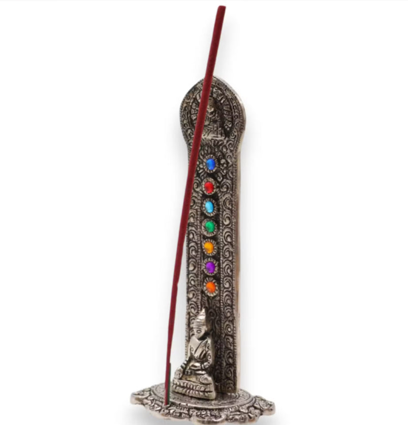 Incense holder with seven colored stones and a Buddha figure on a white background