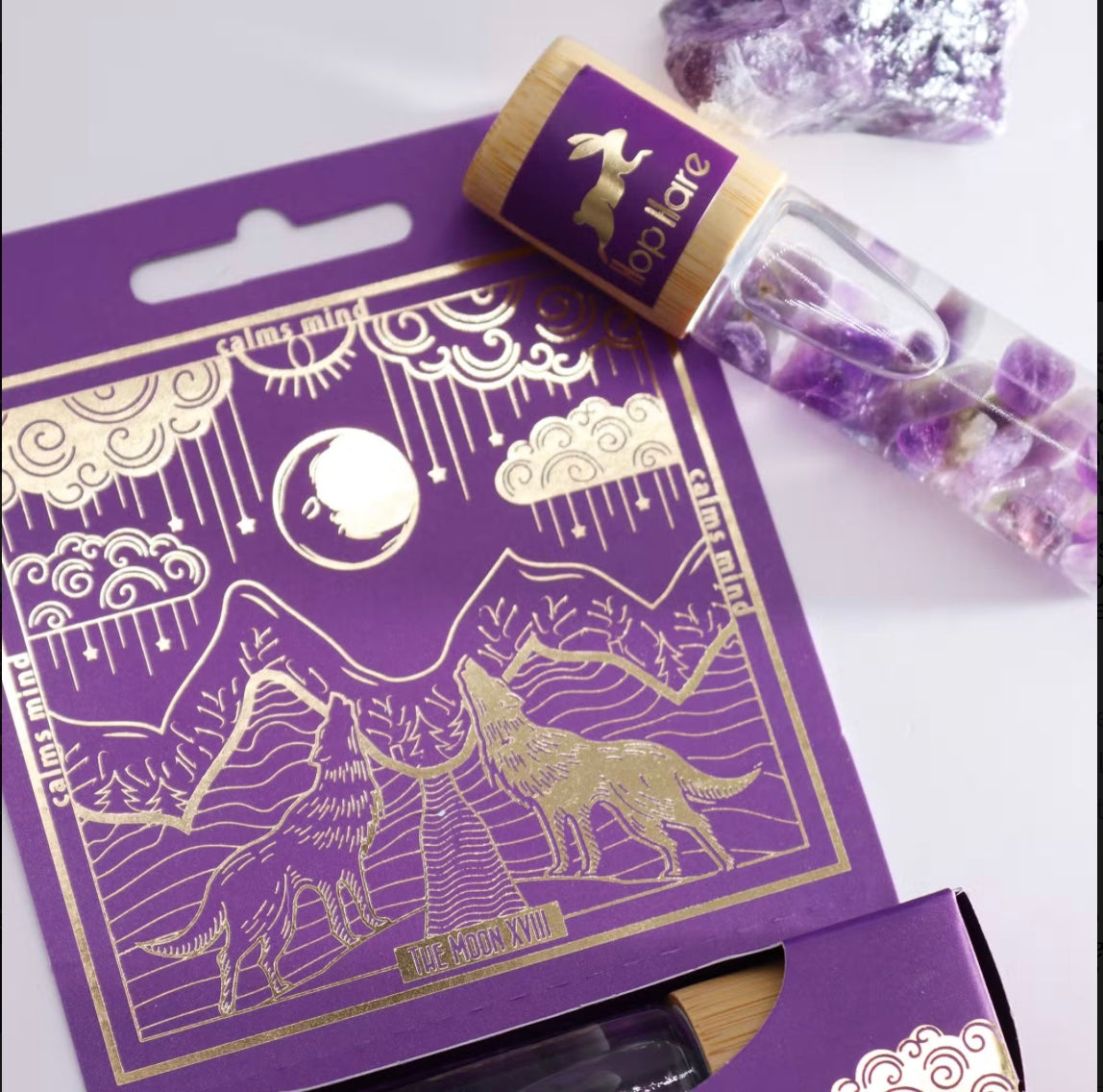Close-up of genuine Amethyst gemstone inside The Moon tarot aromatherapy roll-on.