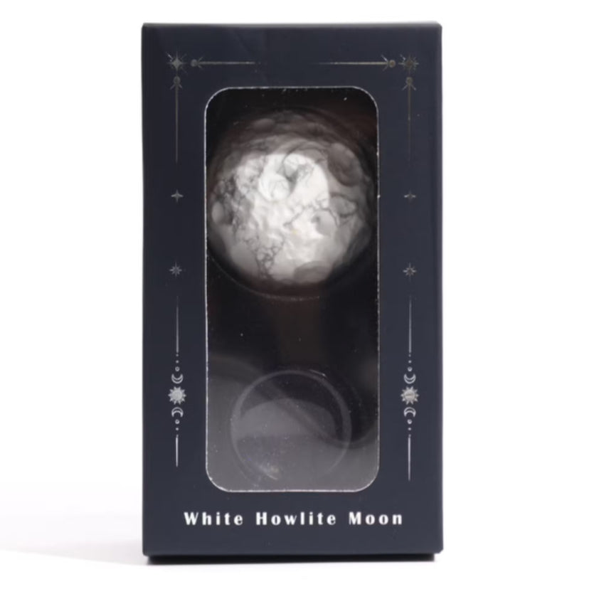 White Howlite Moon stone in a black box with decorative elements on a white background