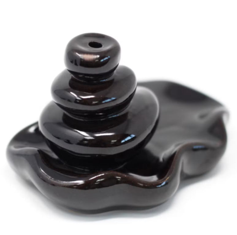Black ceramic incense burner on a white background