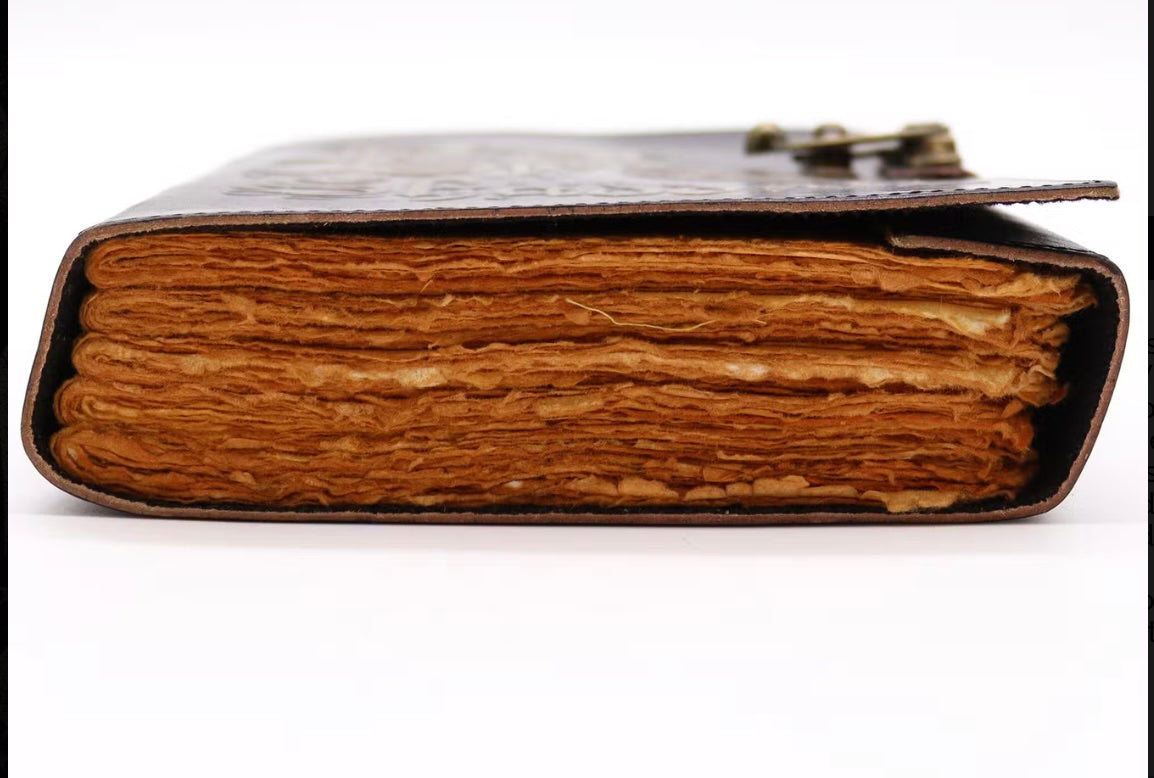 Closed Book of Shadows displaying antique deckle edge pages from the end
