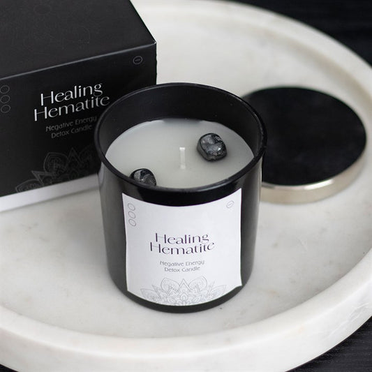 Detox candle infused with Hematite chips, designed to support grounding and energy clearing rituals