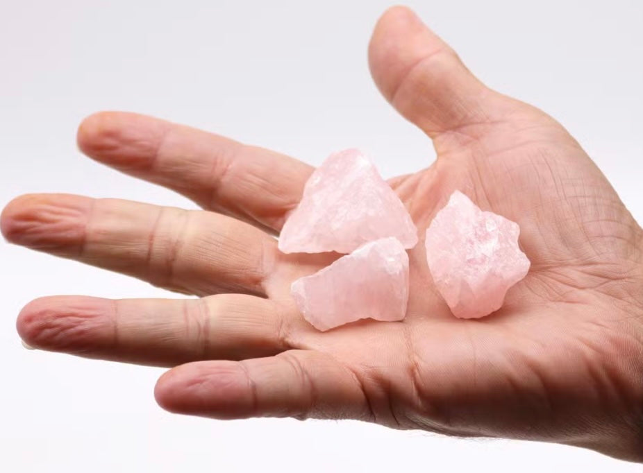 Raw Rose Quartz crystal close-up showing natural pink healing stone texture.