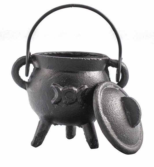 Black cast iron cauldron with a lid on a white background