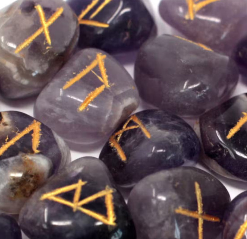 Amethyst stones with orange runes on a white background