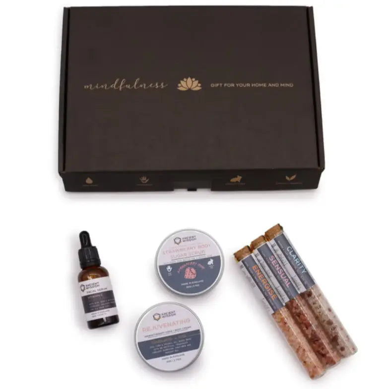 Set of wellness products including a bottle, two containers, and a stick on a white background with 'mindfulness' text above.