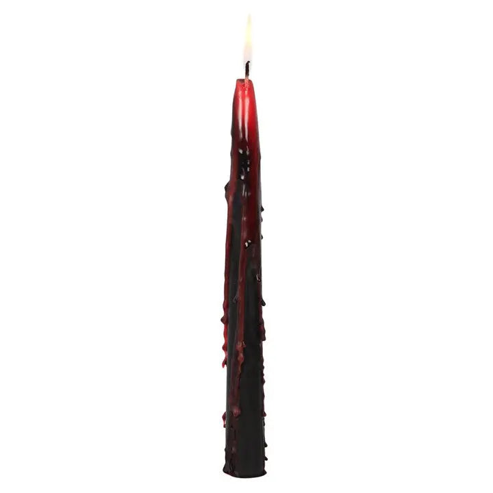 Red candle with a black textured base on a white background
