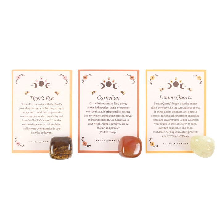 Three crystal stones with descriptive cards on a white background