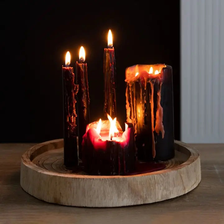 Set of candles with a wooden base on a dark background